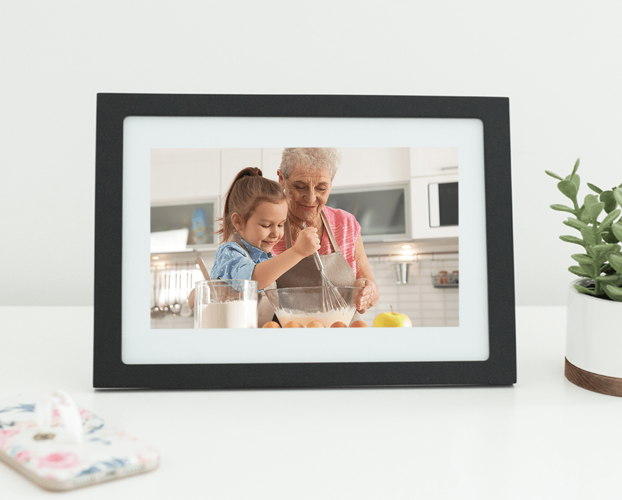 Grandma and granddaughter baking, on display on digital photo frame