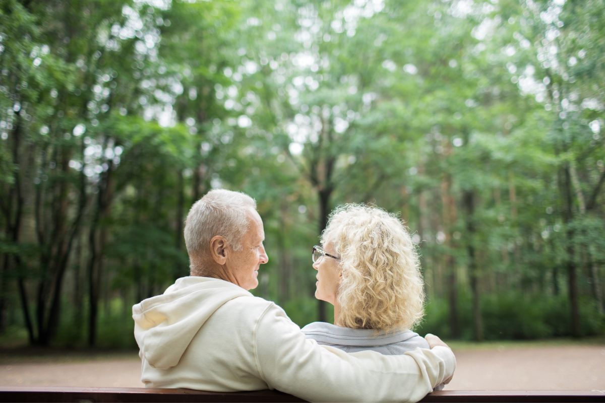 husband and wife on park bench