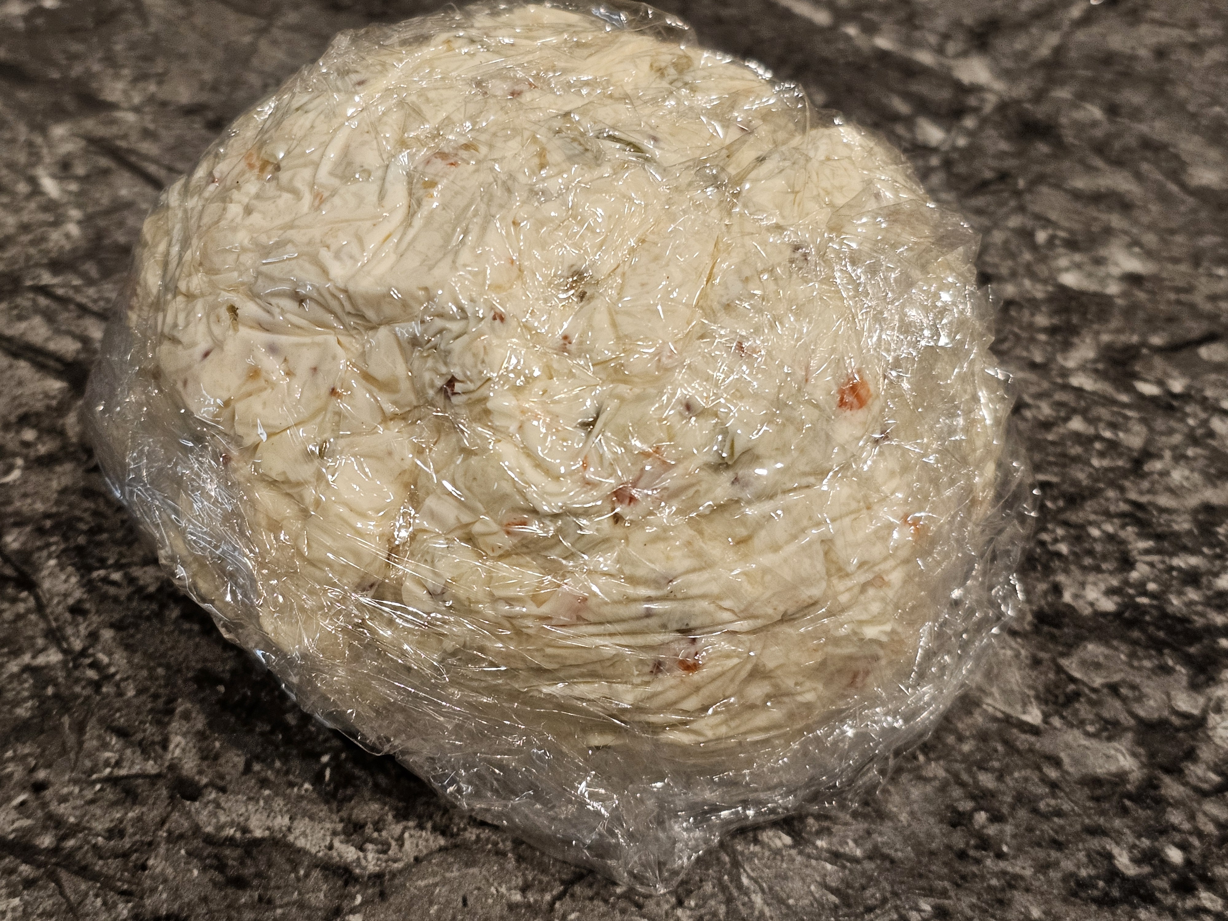 plastic wrapped cheeseball for forming the ball shape