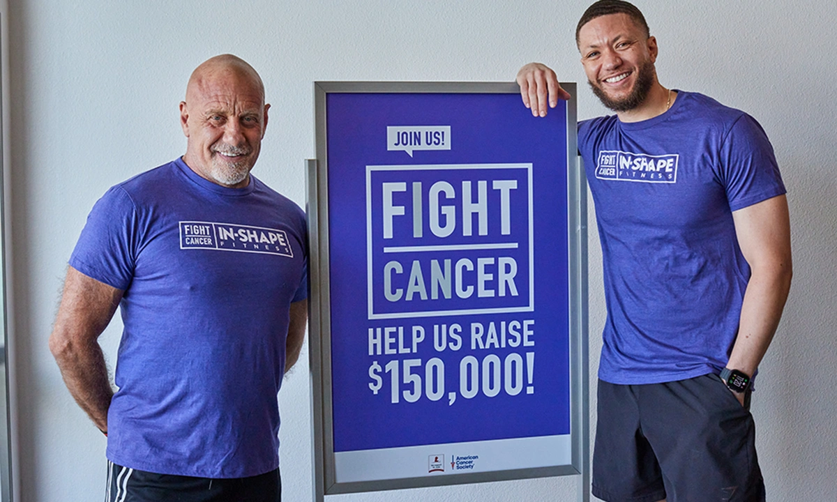 two men standing near donation sign