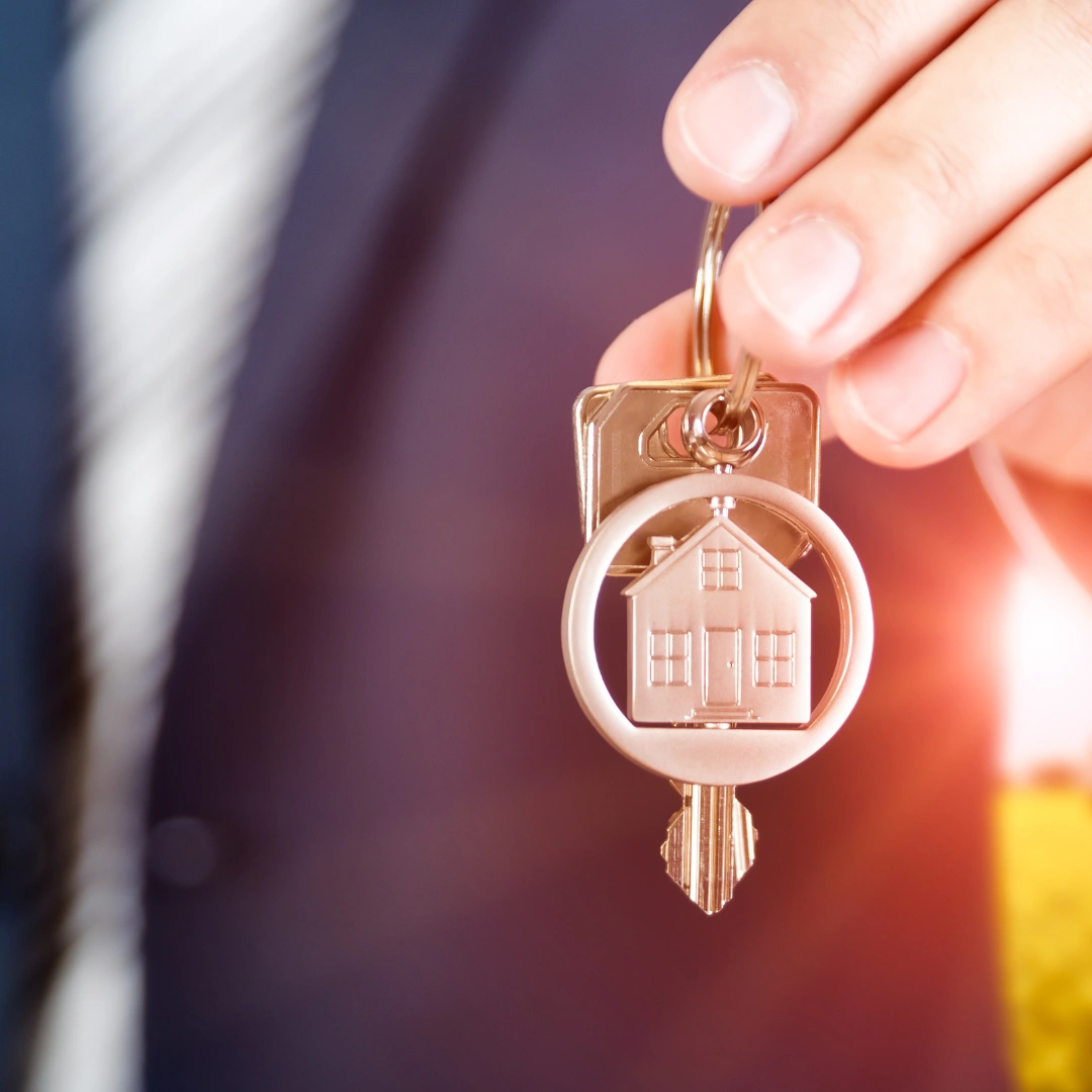 A set of keys being held from a real estate company.