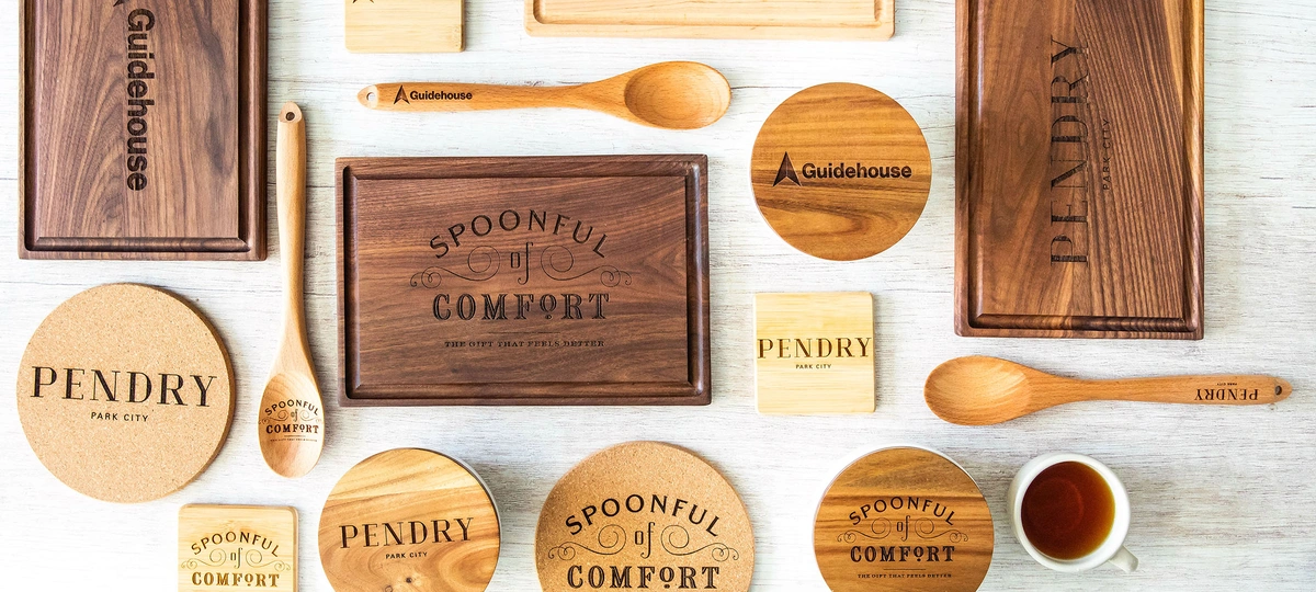  Branded Cutting boards, coasters and spoons organized on a table