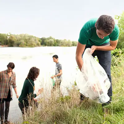 Eco-friendly volunteering work by a stream.