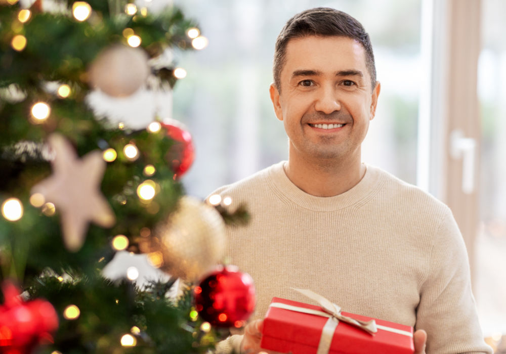A man smiles and holds a present after receiving a holiday loan for Florida payday loans