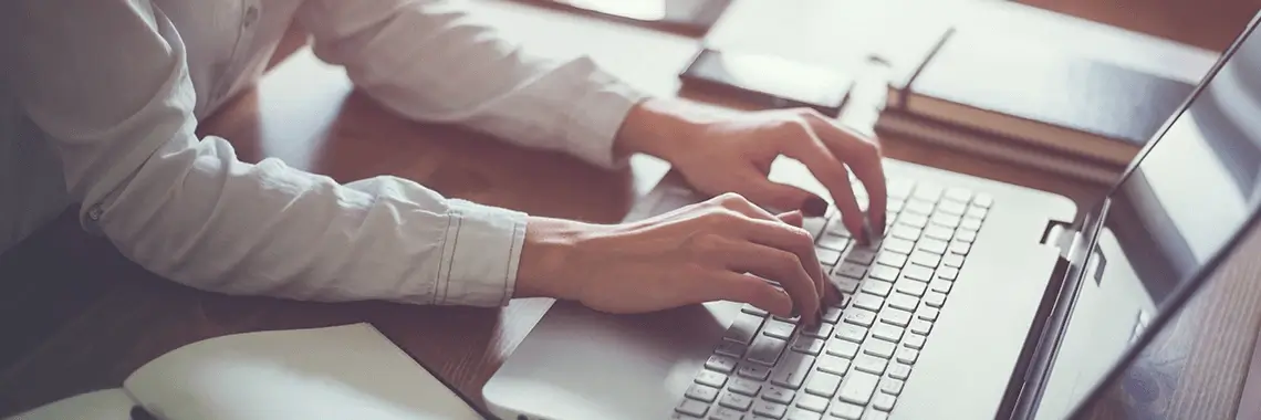 Man typing on a computer.