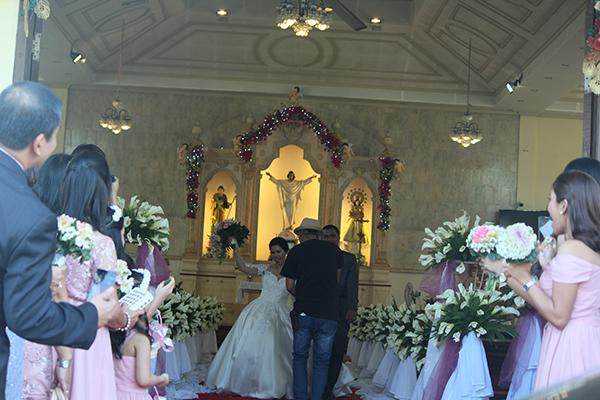 Videographer taking shots of the newly wed