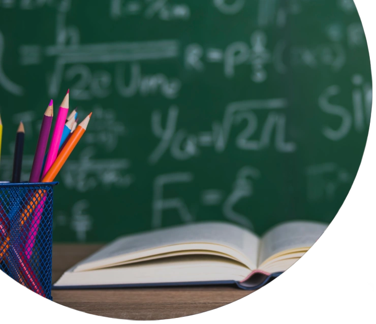 Books and blackboard on wooden background