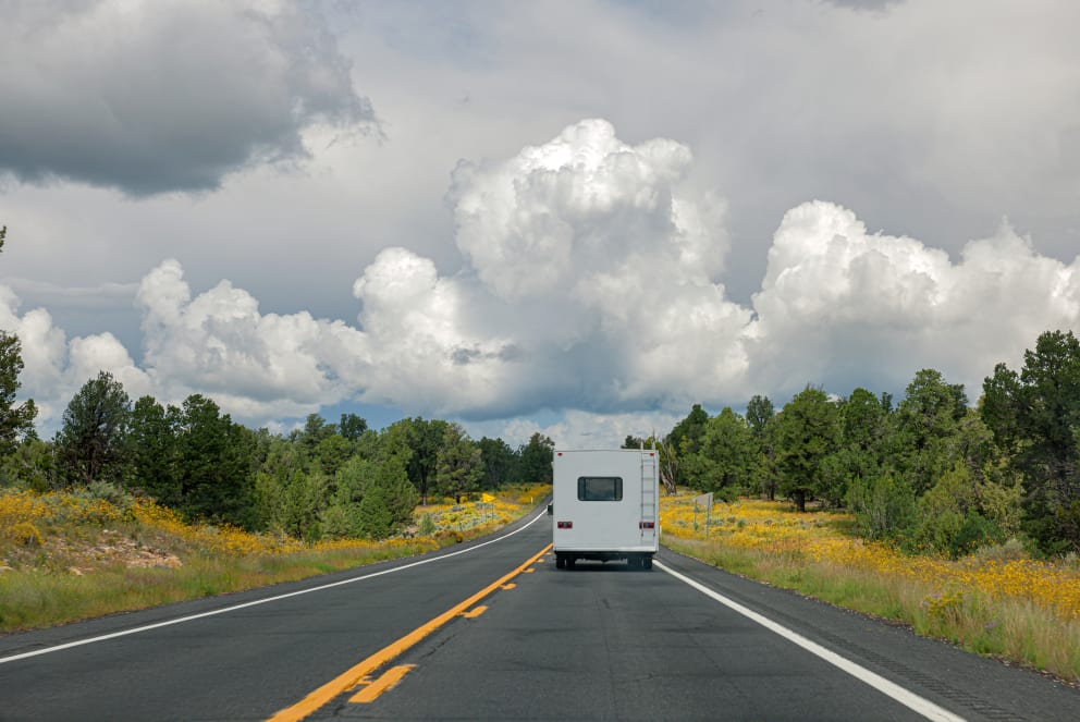 RV driving through forest in Arizona