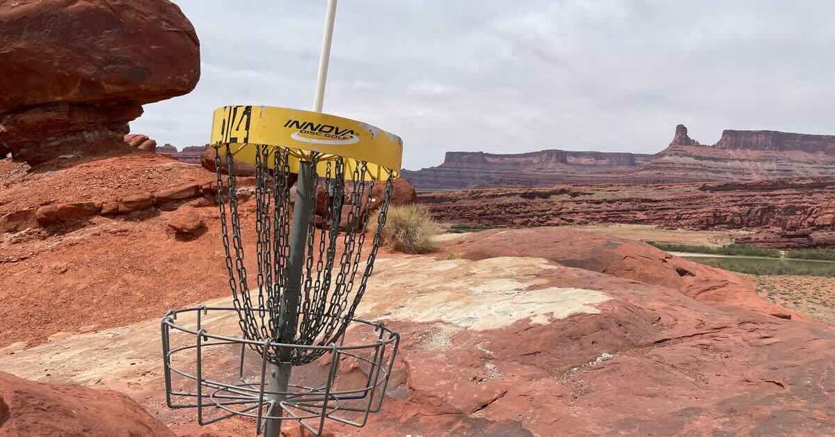 A disc golf basket in a red rock desert