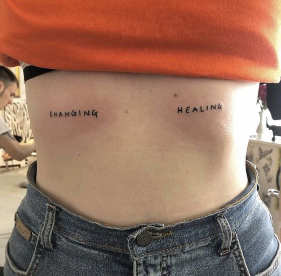 quote tattoo on woman's belly