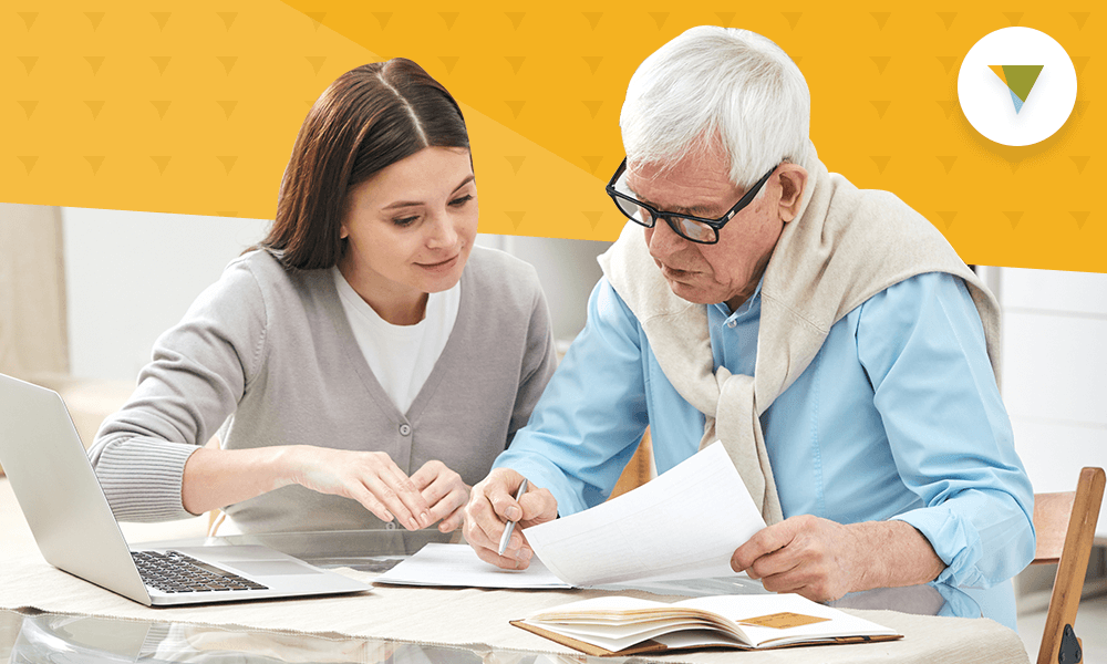 Woman helping man with paperwork
