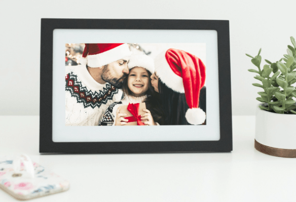 Digital photo frame with family celebrating Christmas