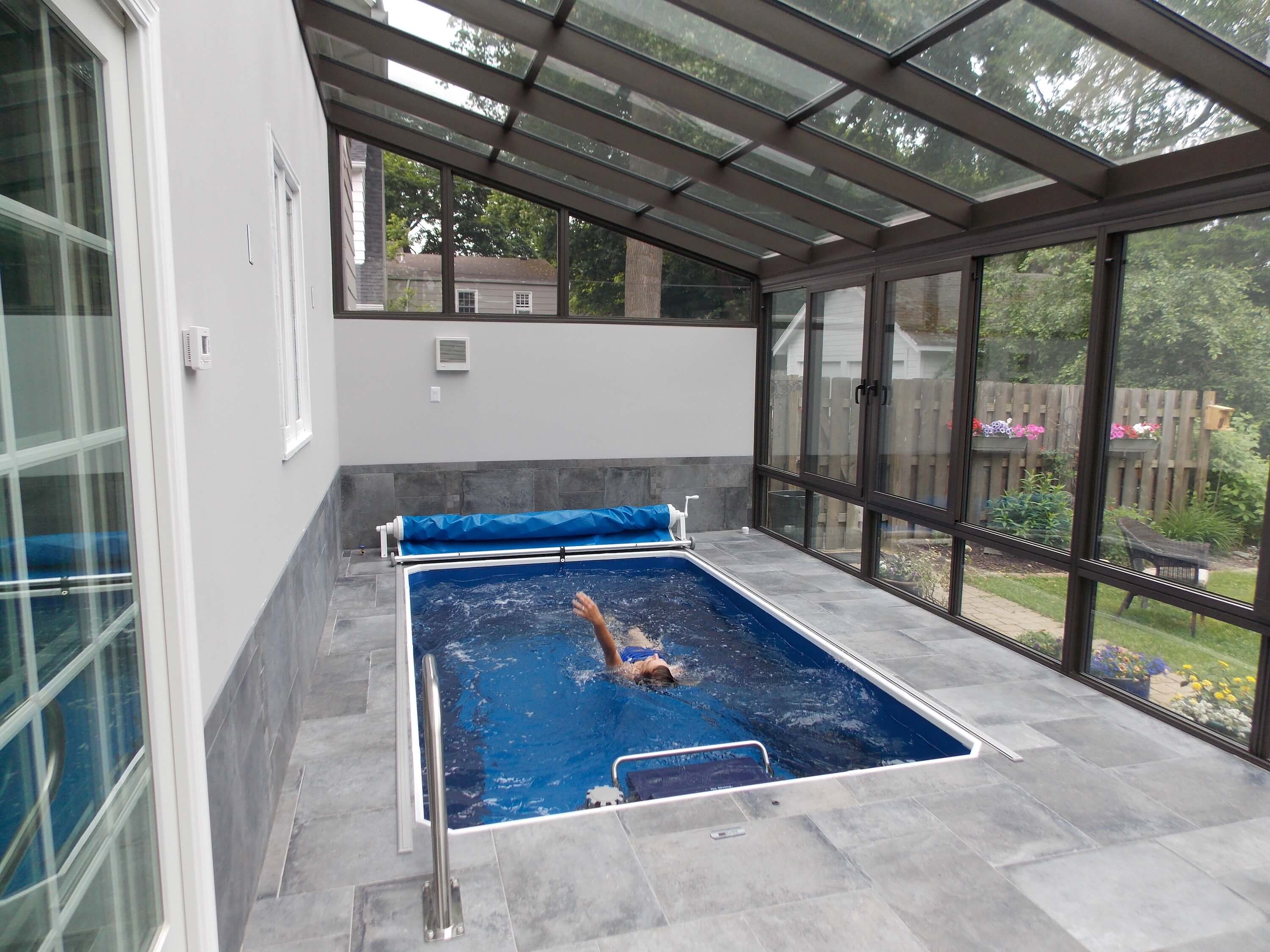 a fully in-ground Endless Pool in a pool enclosure in Rochester, New York.