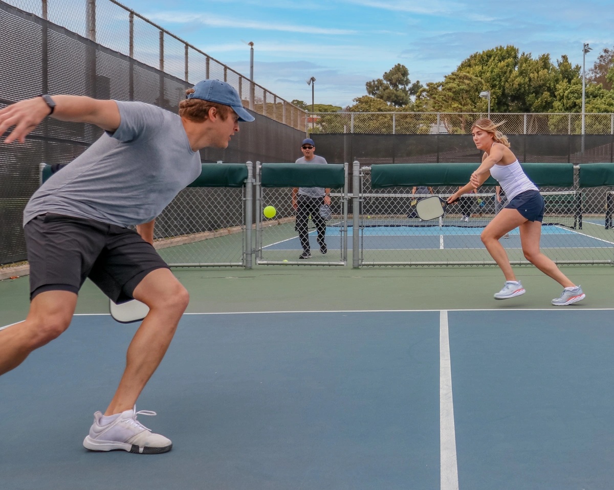 Doubles pickleball - ball going past player at Kitchen line