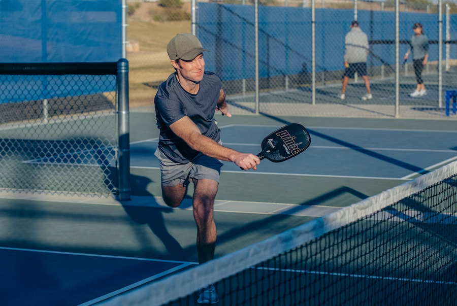 Pickleball player crossing into the kitchen after a volley