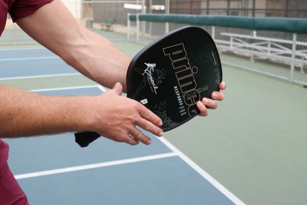 A Man Showing How to Grip a Pickleball Paddle