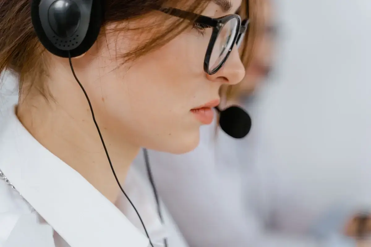 Telemarketer wearing a headset and microphone.