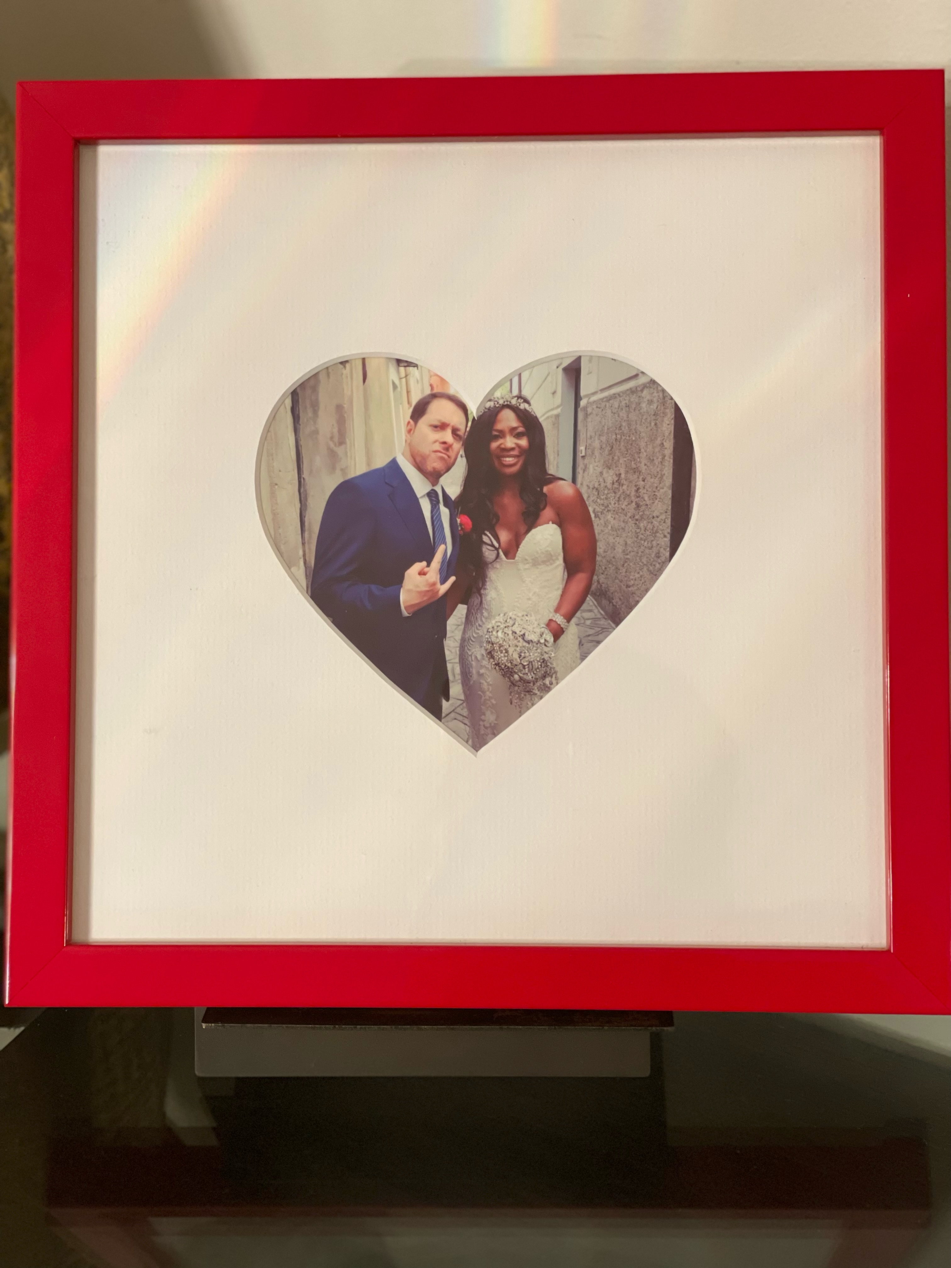heartshaped mat in red frame of married couple