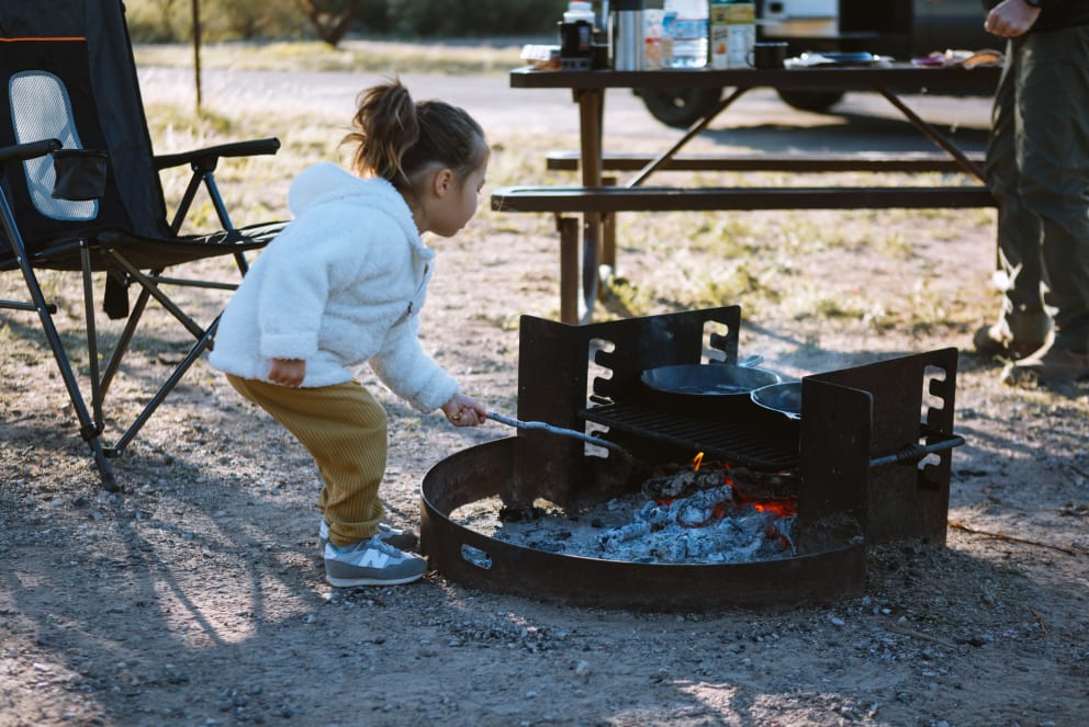 girl in arizona tending to fire