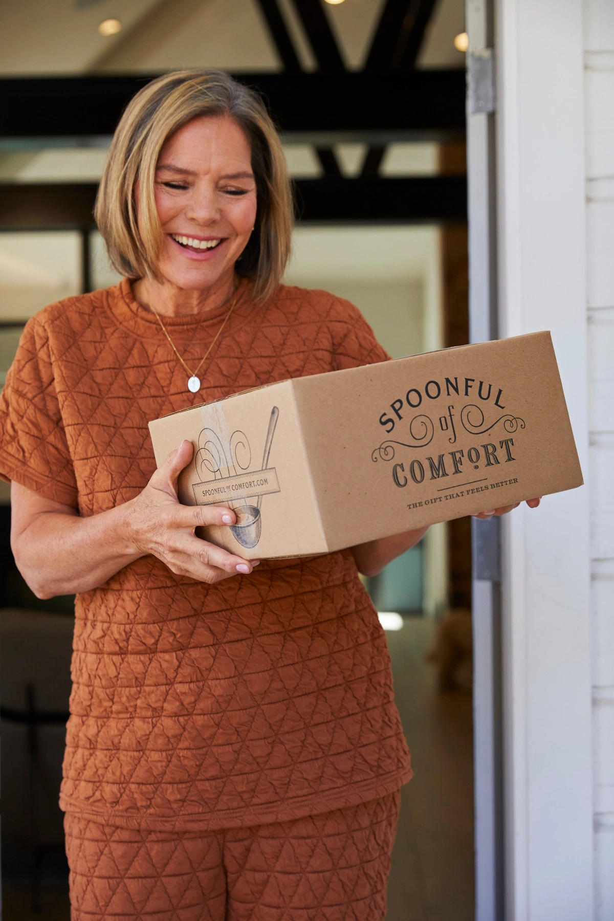 A woman holding a Spoonful of Comfort Package