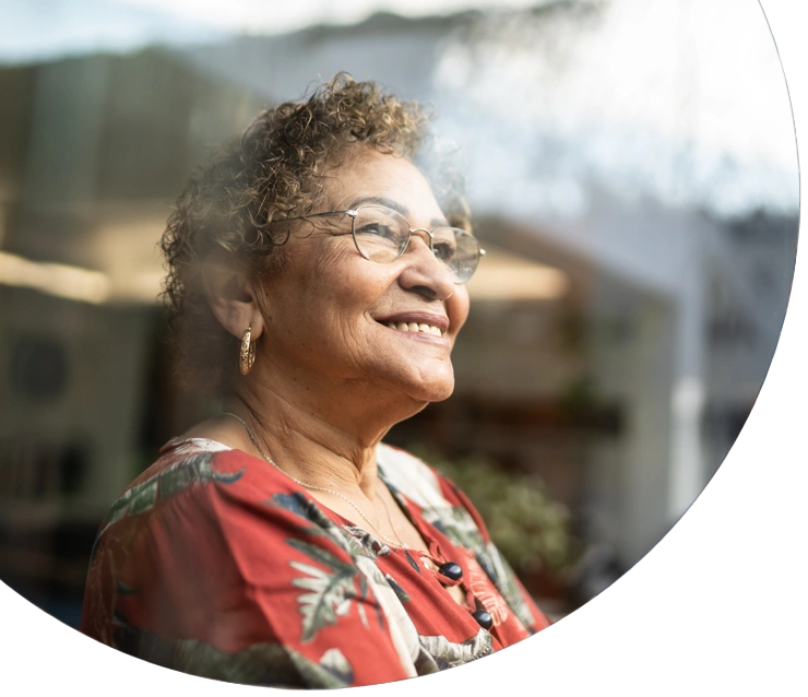 Happy senior woman contemplating at home