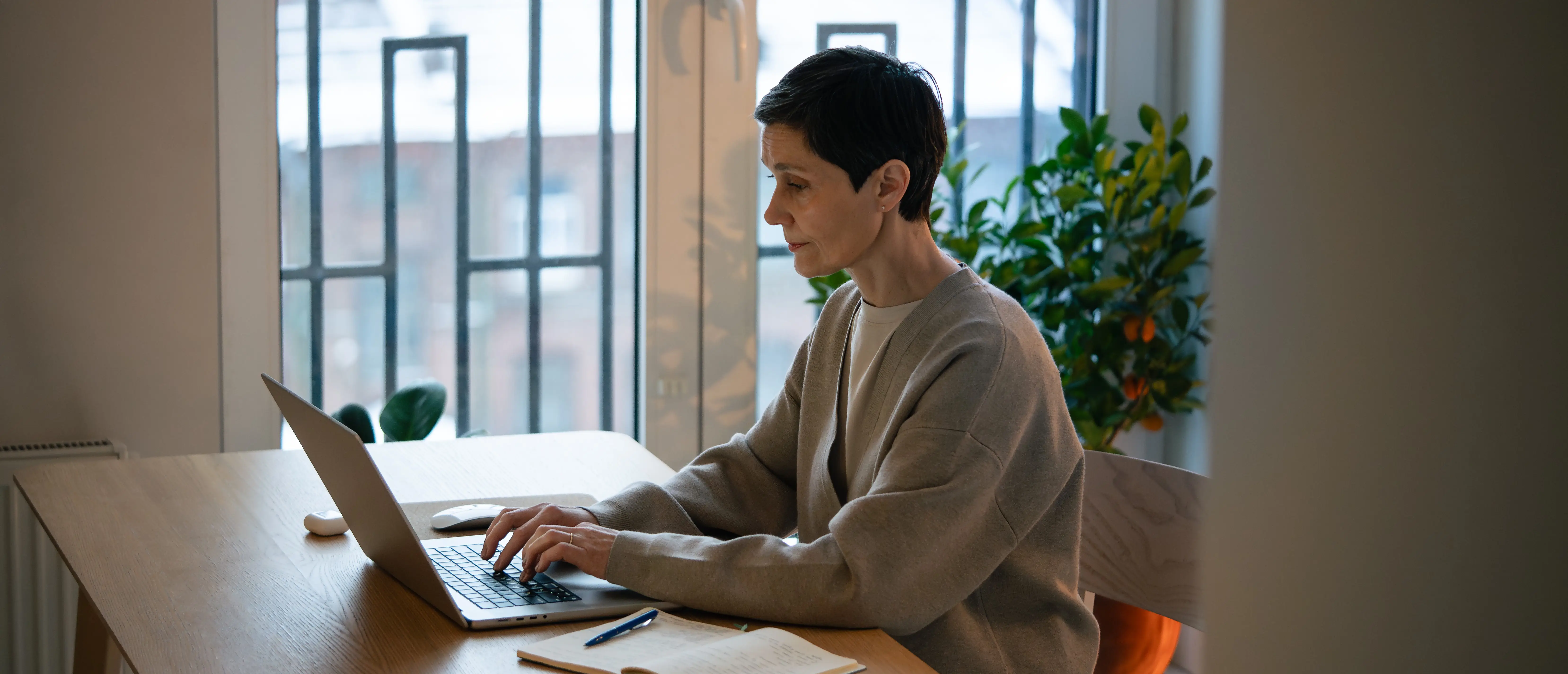 Remote professional concentrating on laptop in distraction free home workspace