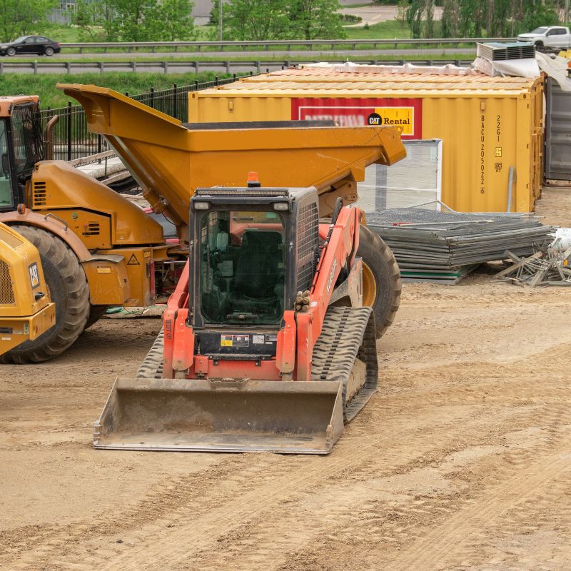 Kubota compact track loader with an ADT behind it on a job site