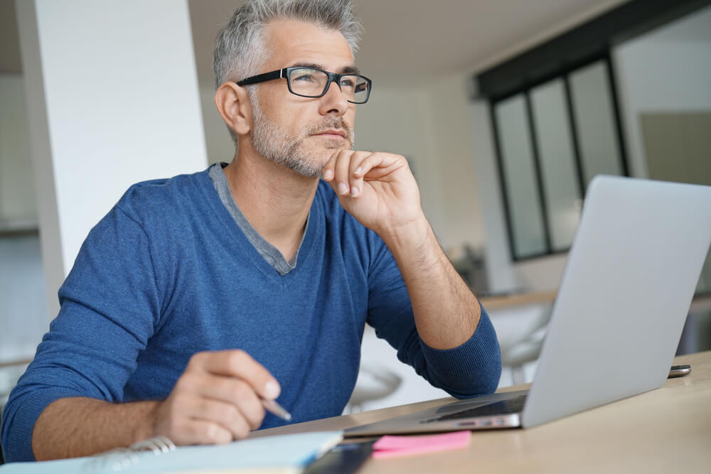 man thinking about getting a title loan online