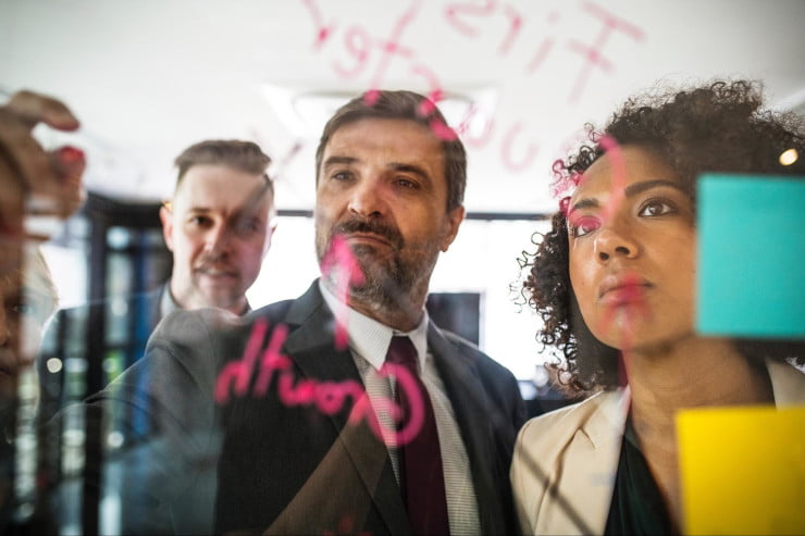 image of two men and a woman working to solve a problem - best social media aggregator