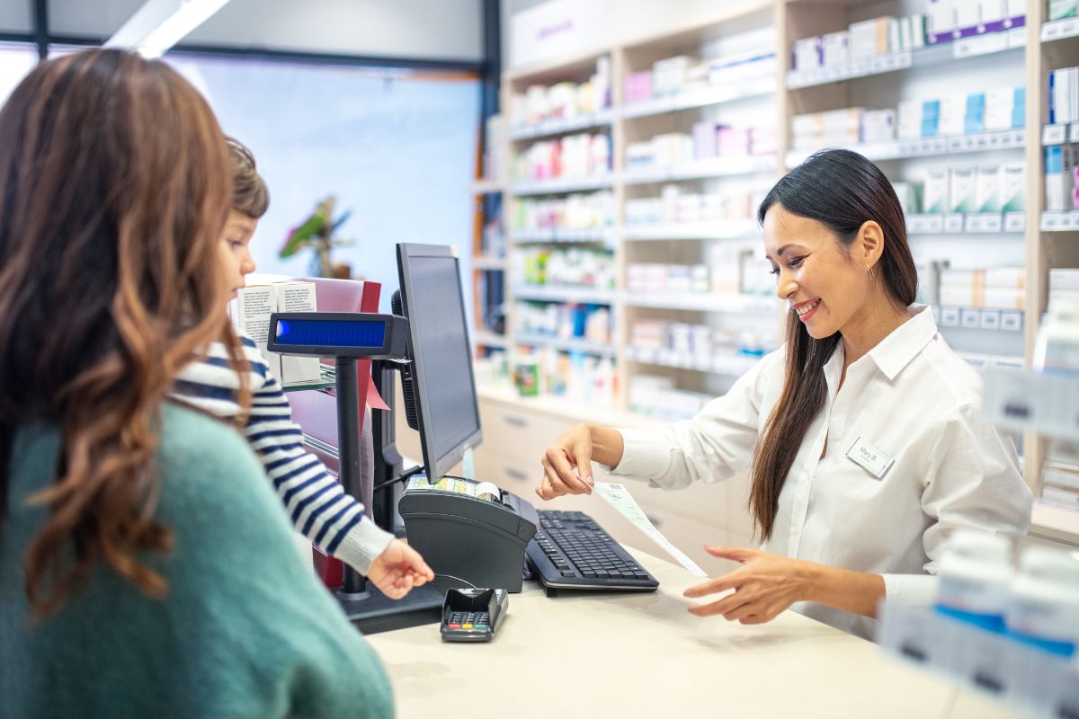 pharmacist helping person with GoodRx
