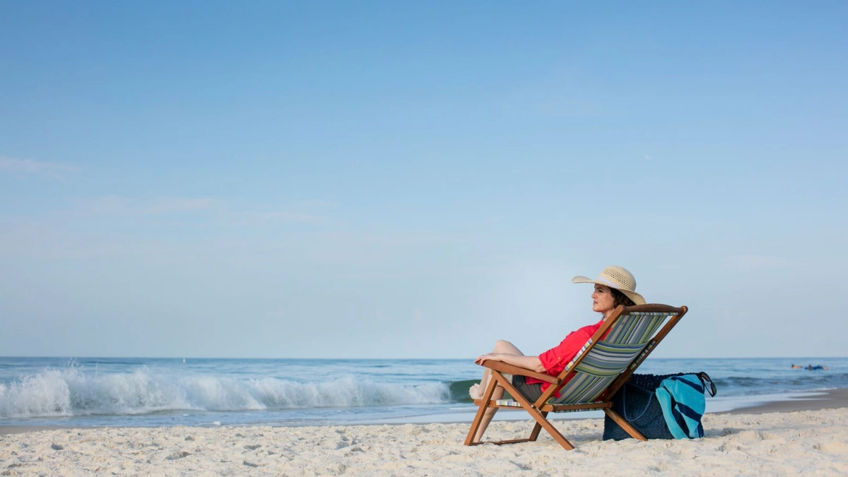 Woman sitting on a beach in a chair