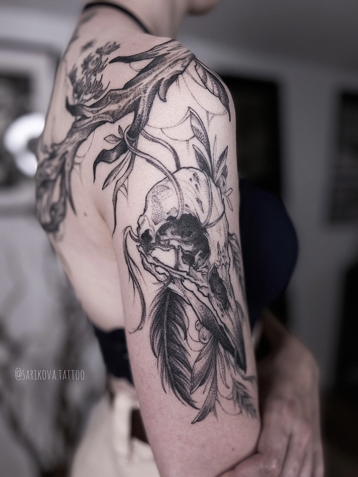 fineline and dotwork tattoo of feathers and natural elements