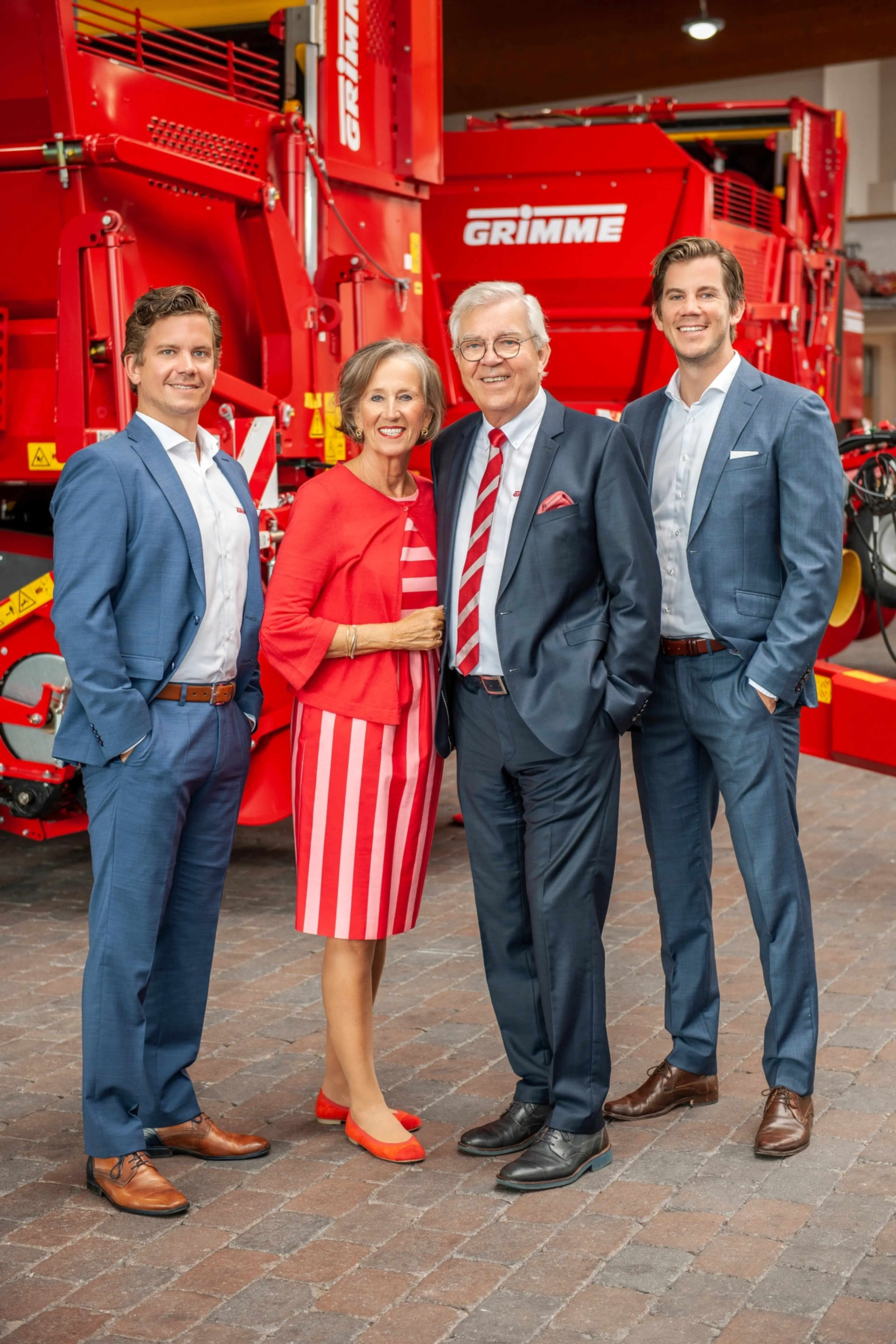 The GRIMME family in front of a potato harvester, type EVO 280.