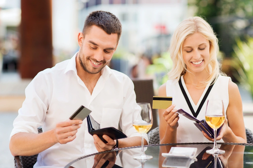Man and woman looking at their bank cards