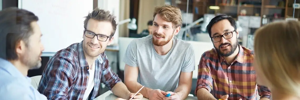 A team of people talking and smiling.