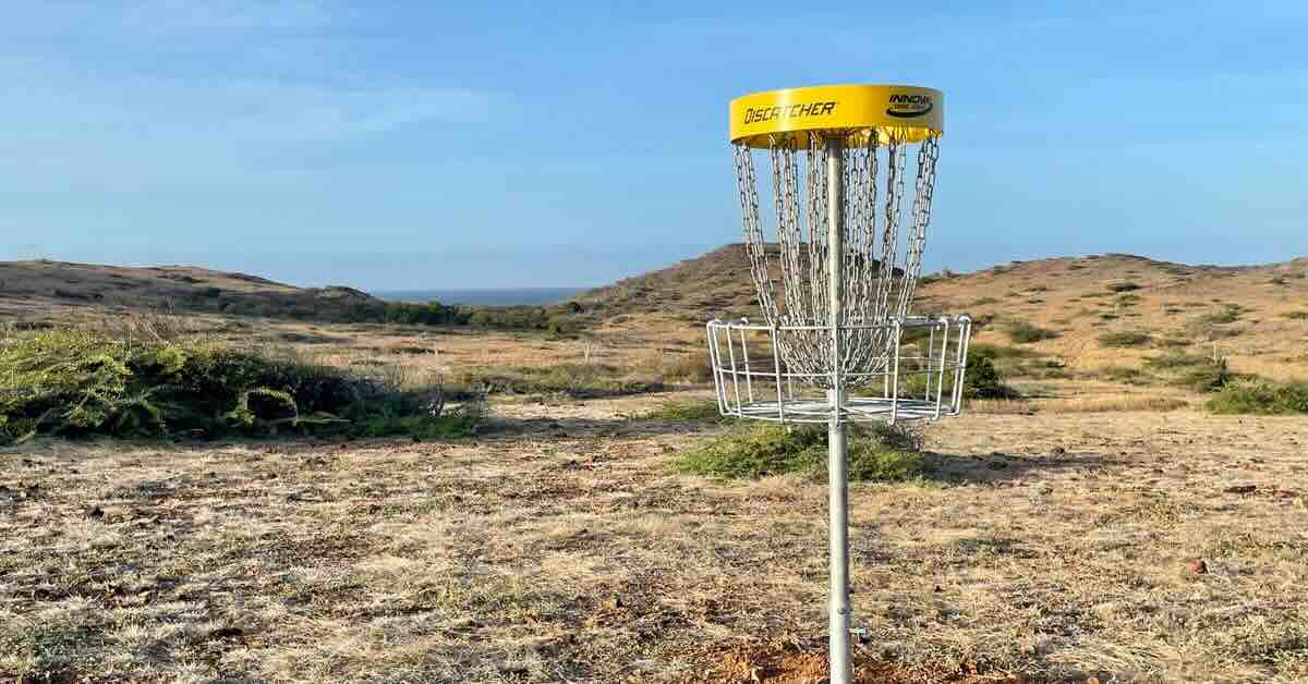 A basket in an open area with hint of sea in the distance