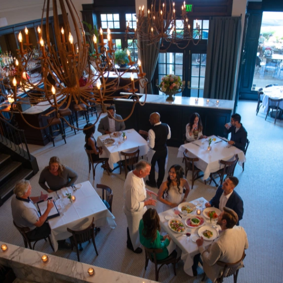 People enjoying meal inside restaurant.