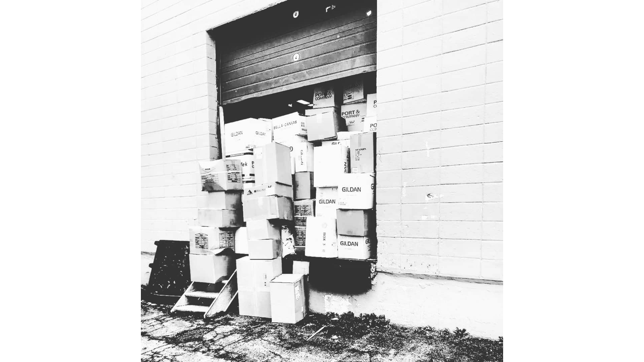 T-shirts from Gildan sitting on a loading dock waiting for screen printing.