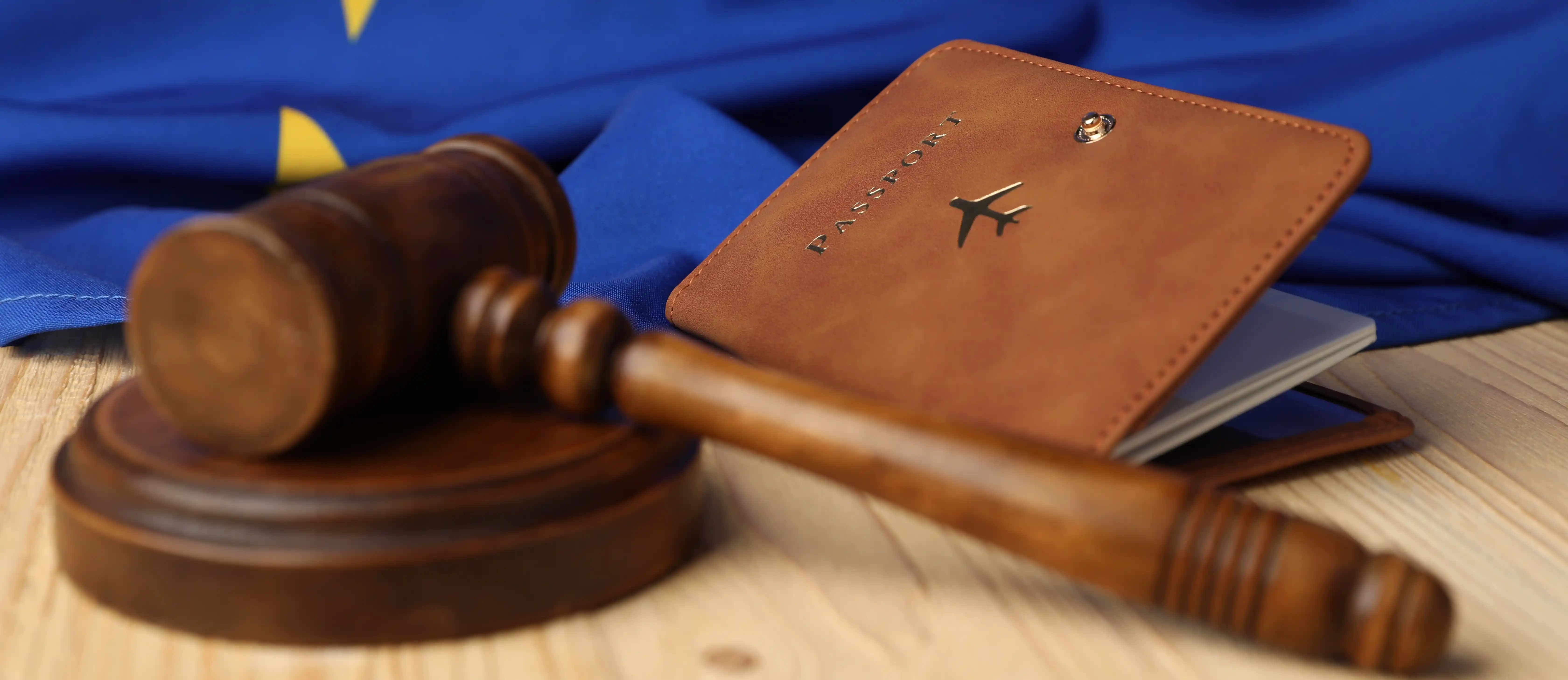 Judge gavel with passport and EU flag representing international legal compliance
