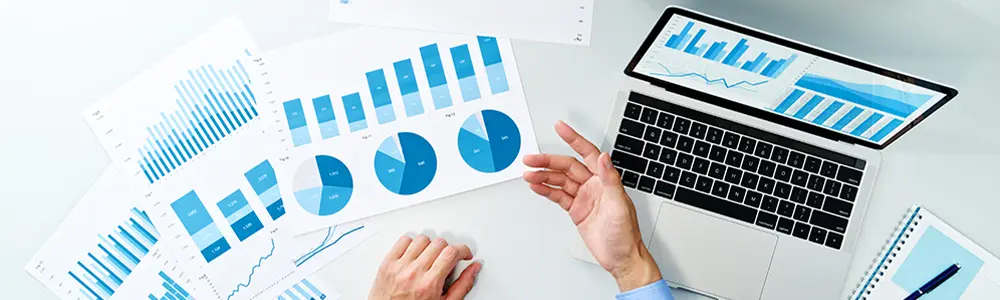 professional hands reviewing documents on table with other graphs