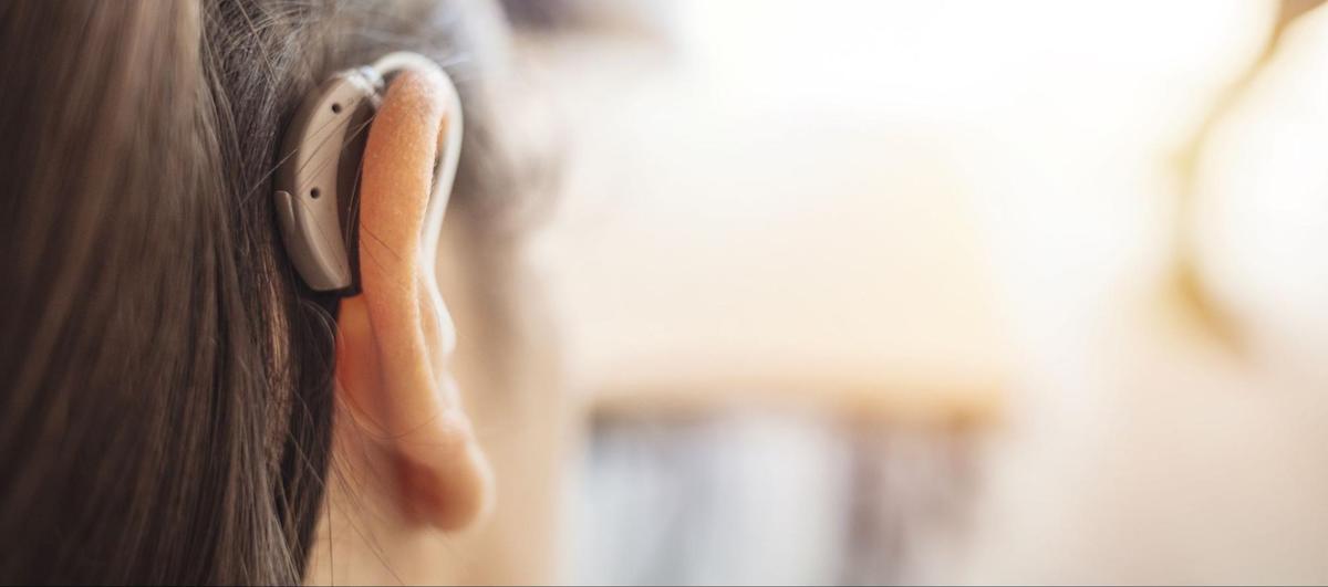 Amplifon: Close up shot of a woman's ear wearing a hearing aid