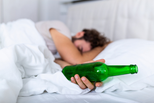 Man sleeping with a beer in his hand