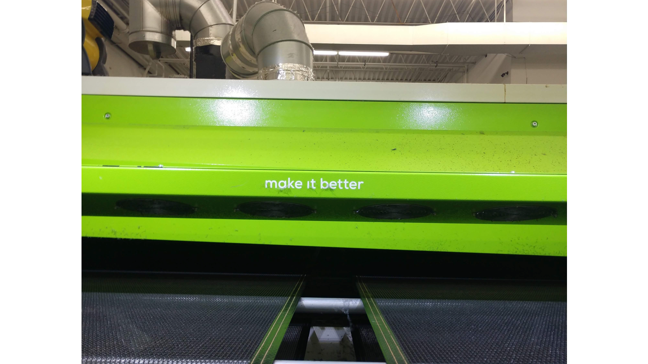 A conveyor dryer for screen printing made by ROQ that says "Make it better"