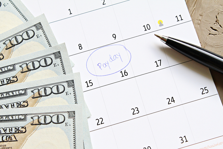 Calendar with payday circled and cash