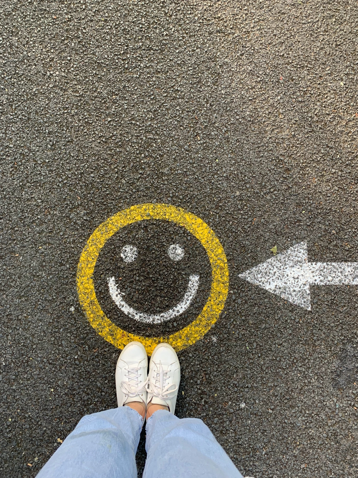 A chalk drawing of a smiley face on a path indicates a positive customer experience.