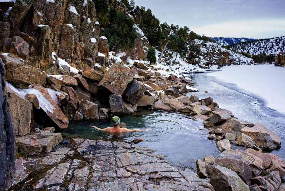 man in hot spring in mountains