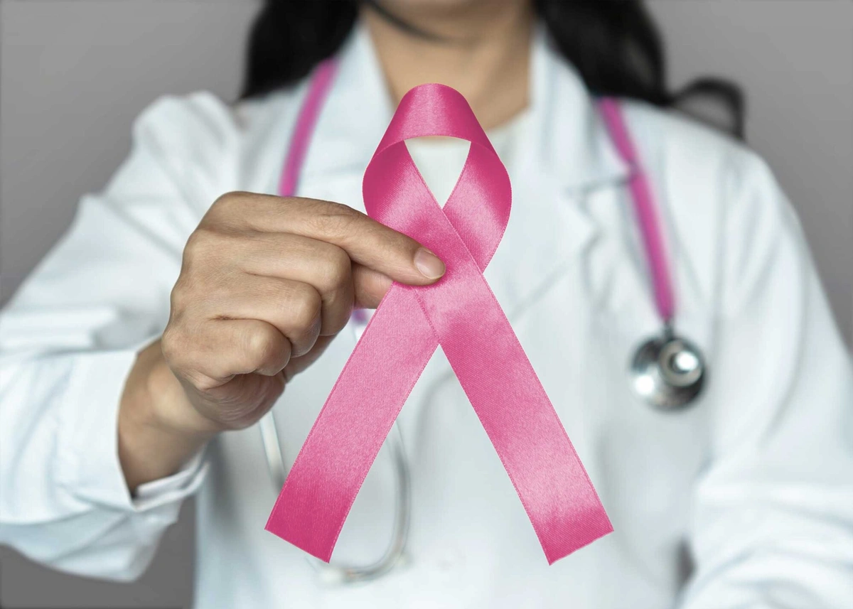 photo-RSCNJ-pink-breast-cancer-ribbon-held-by-woman-in-lab-coat-2000x1429.webp