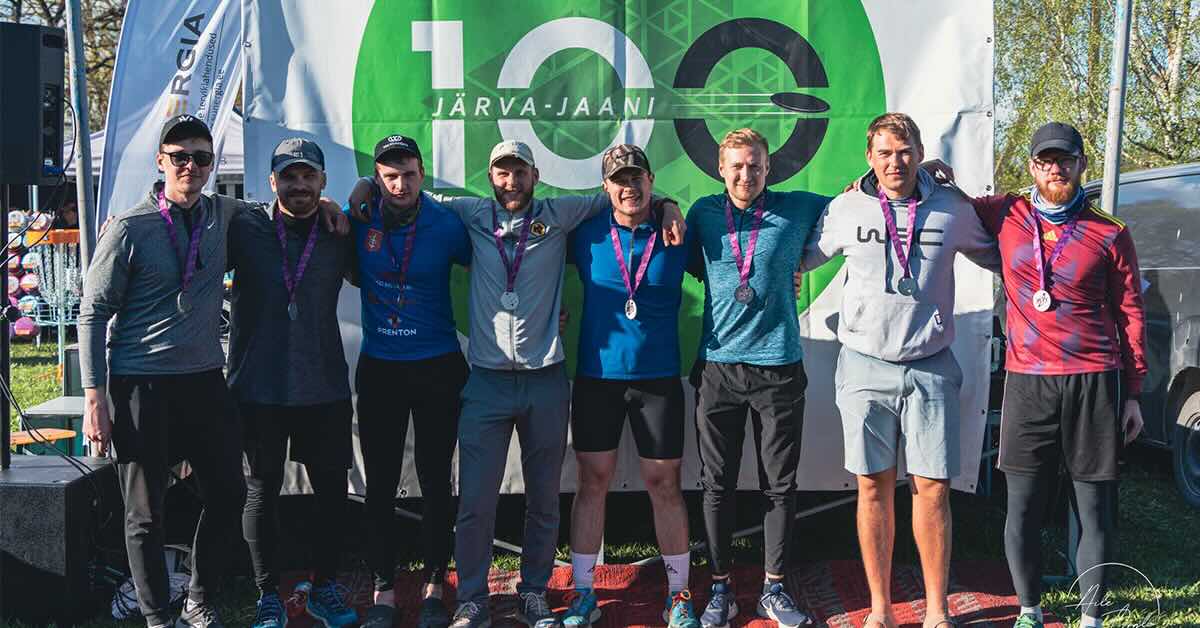 Men posing for a photo with medals