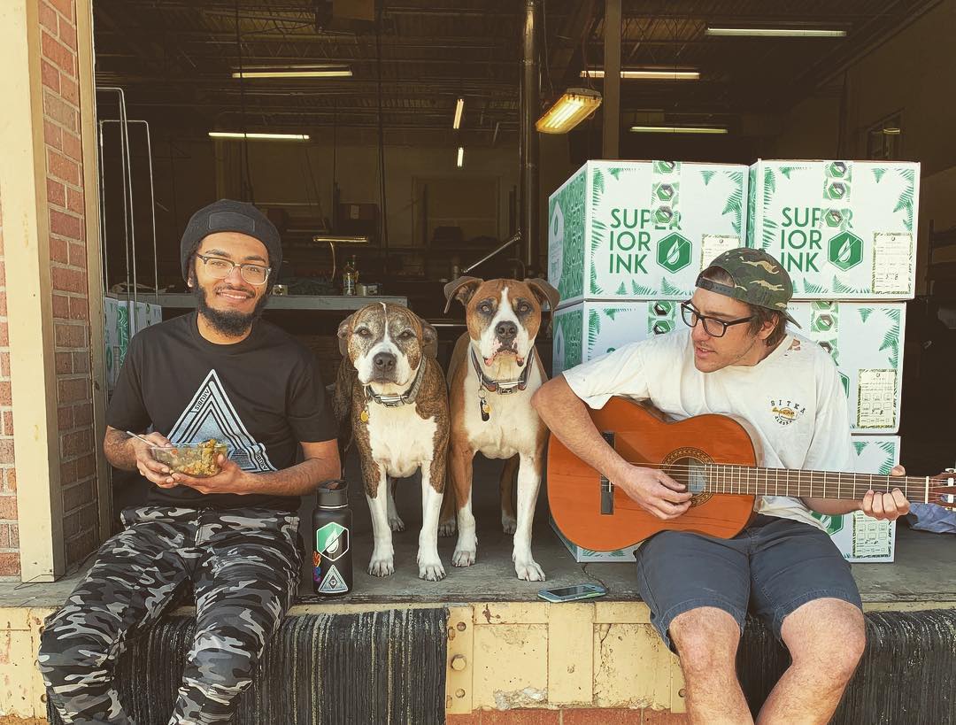 Superior Ink's team (and shop dogs) hang out during some downtime.