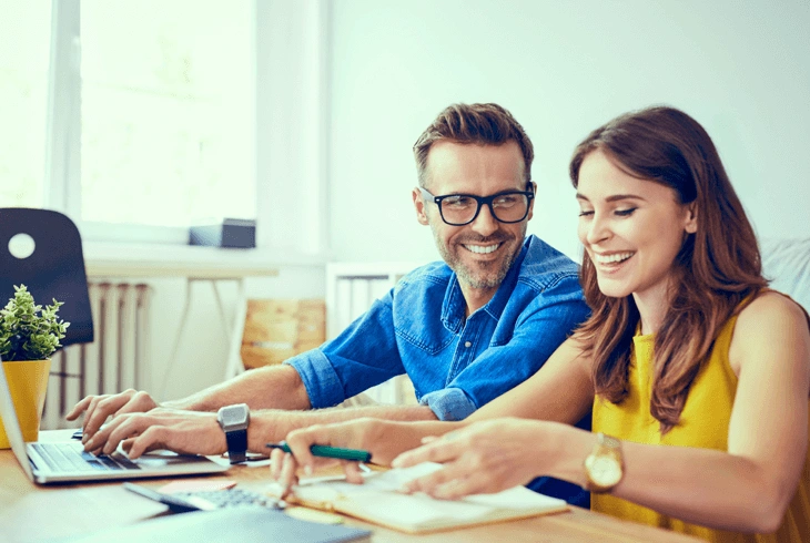 Couple at a table going through loan paperwork